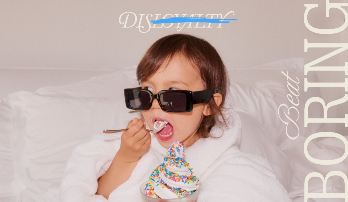 A child in a fluffy white robe wearing sunglasses enjoys a bowl of colorful sprinkles topped dessert, with playful text overlay.